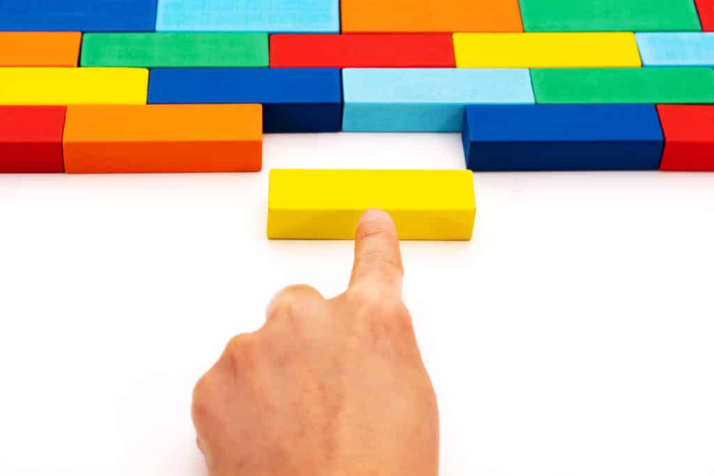 Hand moving yellow block into maze of colored blocks to fill in space Parliamentary Procedure